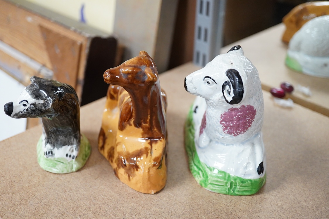 A Staffordshire Pearlware figure of a recumbent ewe, a Staffordshire glazed terracotta figure of a recumbent deer and a Staffordshire pearlware model of a badger?, largest 14cm wide